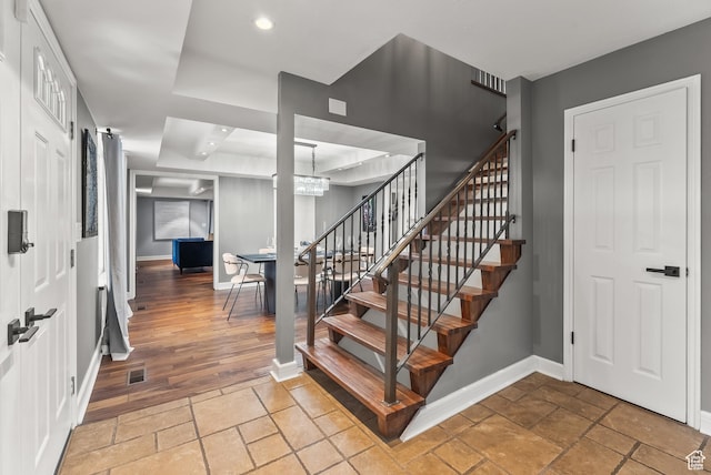 3338 E Creek Rd, Cottonwood Heights, UT 84121 - stairway featuring stone tile floors, recessed lighting, a chandelier, and a raised ceiling