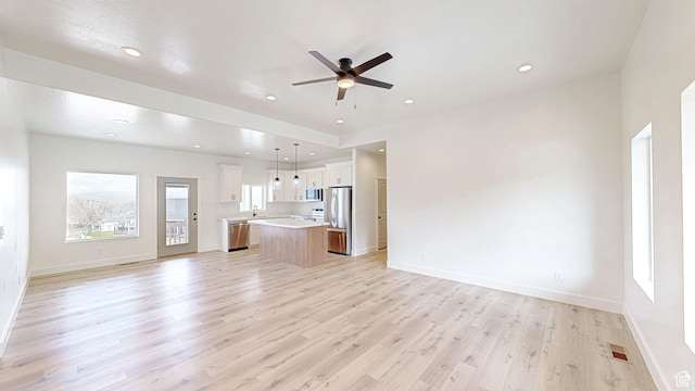 unfurnished living room with visible vents, baseboards, a ceiling fan, light wood finished floors, and recessed lighting