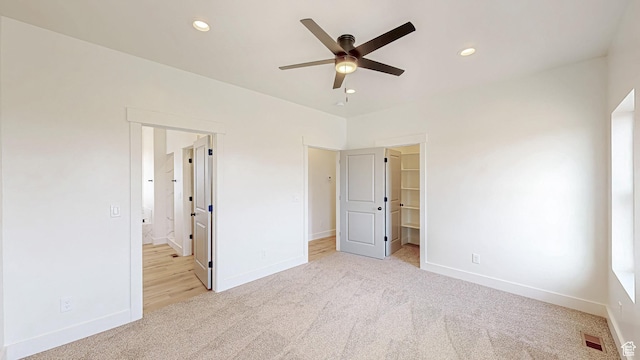 unfurnished bedroom featuring light colored carpet, baseboards, and recessed lighting