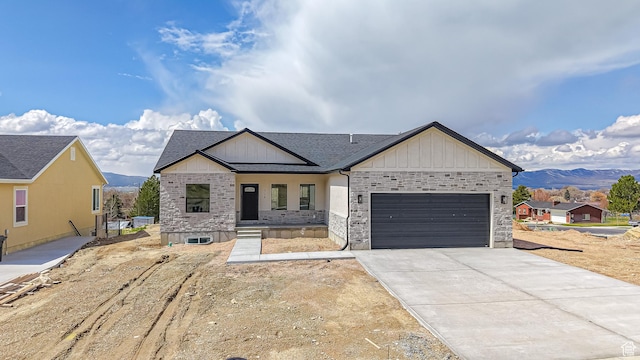 modern inspired farmhouse featuring board and batten siding, a mountain view, a garage, and concrete driveway