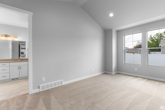 11888 S Golden Pine Ln, Riverton, UT 84065 - spare room featuring light colored carpet, a sink, vaulted ceiling, and visible vents
