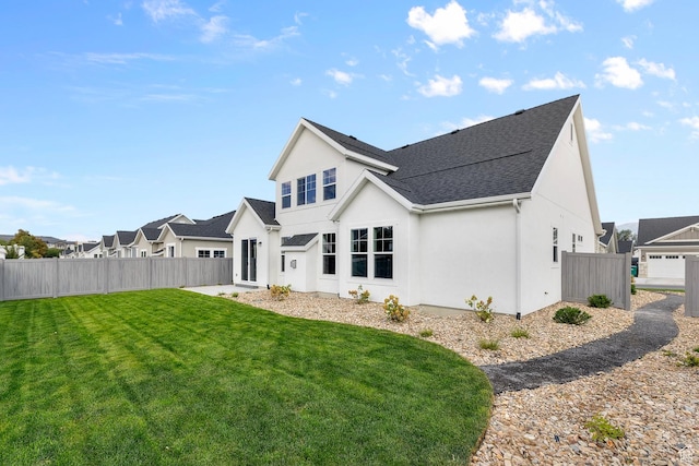 11888 S Golden Pine Ln, Riverton, UT 84065 - rear view of property featuring a yard, roof with shingles, stucco siding, and fence