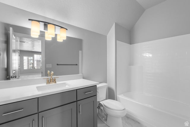 full bathroom featuring toilet, a textured ceiling, vanity, vaulted ceiling, and marble finish floor