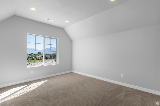 bonus room featuring carpet, visible vents, baseboards, and vaulted ceiling