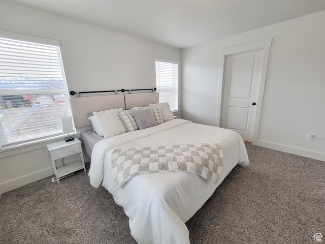 bedroom featuring baseboards and carpet