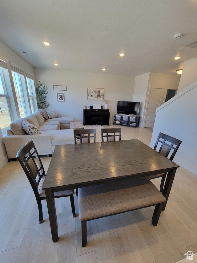 dining room featuring visible vents, light wood finished floors, and recessed lighting
