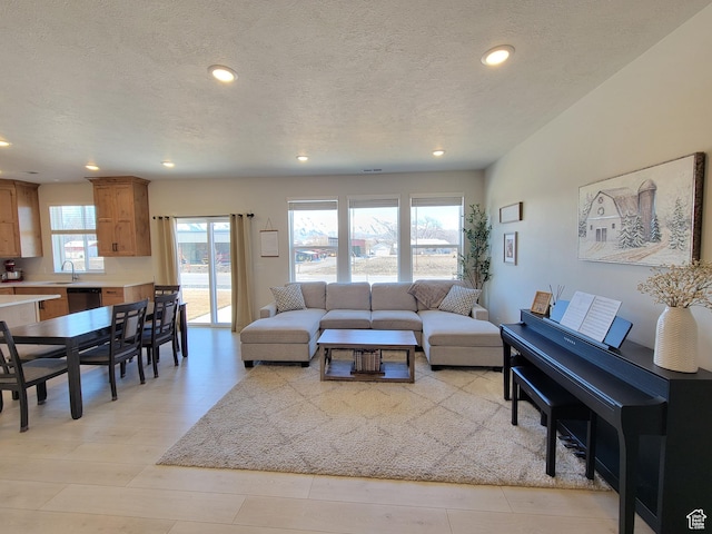 living room featuring recessed lighting and a textured ceiling