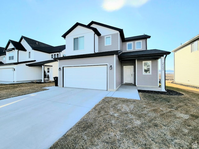 view of front of home featuring concrete driveway and an attached garage