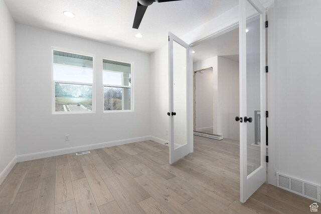 unfurnished bedroom with french doors, visible vents, baseboards, and light wood-type flooring