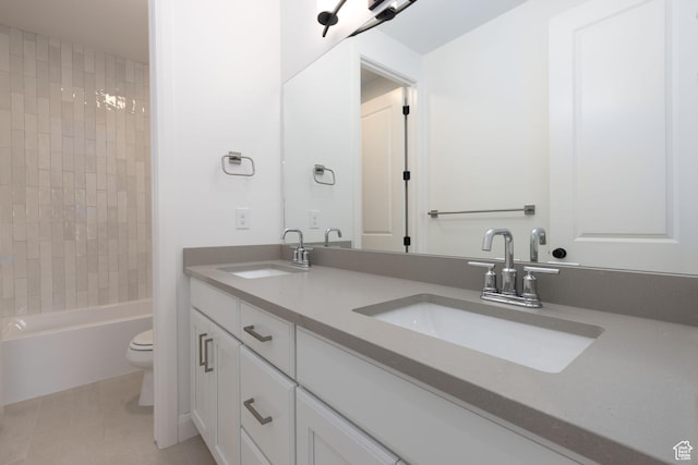 full bathroom featuring tile patterned flooring, double vanity, a sink, and toilet