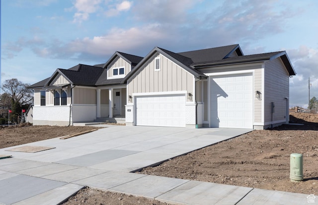 modern farmhouse style home with a garage, driveway, and board and batten siding