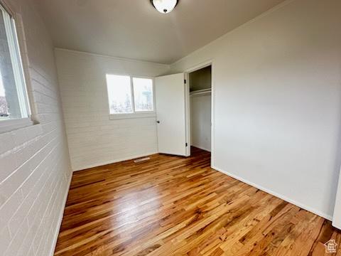 unfurnished bedroom featuring a closet and wood finished floors