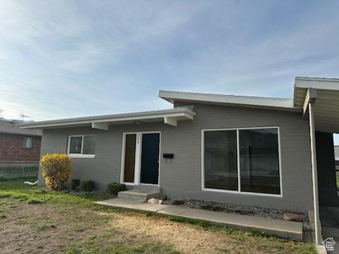 back of property featuring a lawn