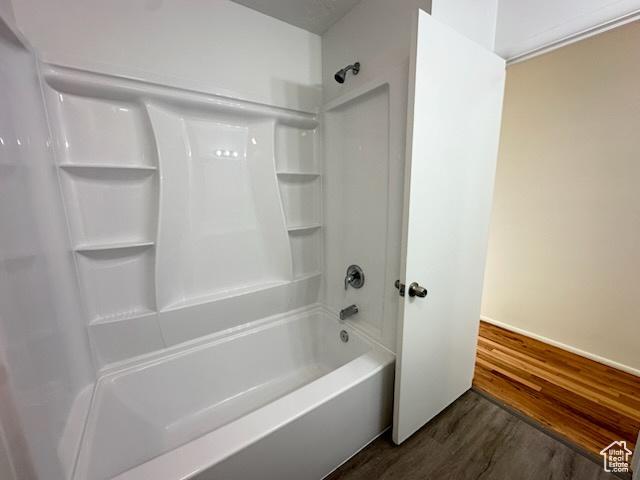 bathroom featuring shower / bathing tub combination and wood finished floors