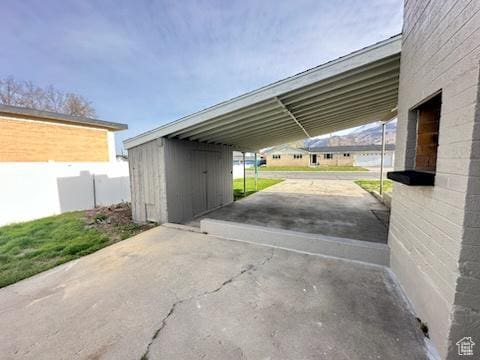 view of parking with a carport and driveway