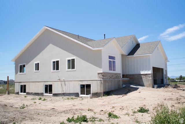 3639 S Macy Ln, West Haven, UT 84401 - view of side of property with a shingled roof, stone siding, and an attached garage