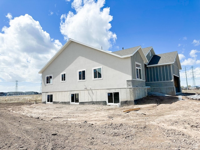 view of side of home featuring a shingled roof