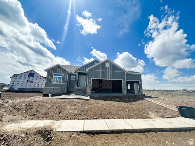 property under construction with board and batten siding and a garage