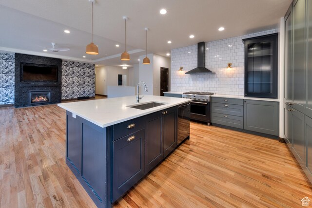 284 W Mcgill Blvd, Moab, UT 84532 - kitchen with high end stainless steel range oven, recessed lighting, light countertops, wall chimney exhaust hood, and a sink