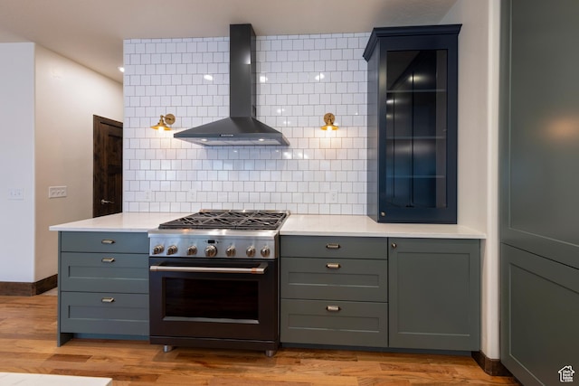 284 W Mcgill Blvd, Moab, UT 84532 - kitchen featuring gray cabinets, high end range, wall chimney exhaust hood, and light wood-type flooring