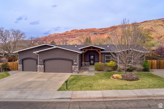 284 W Mcgill Blvd, Moab, UT 84532 - ranch-style home with stucco siding, driveway, a front lawn, a garage, and fence