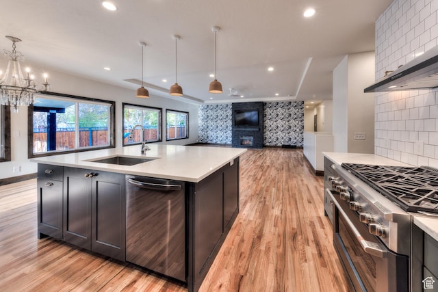 284 W Mcgill Blvd, Moab, UT 84532 - kitchen with light wood finished floors, open floor plan, a sink, and appliances with stainless steel finishes