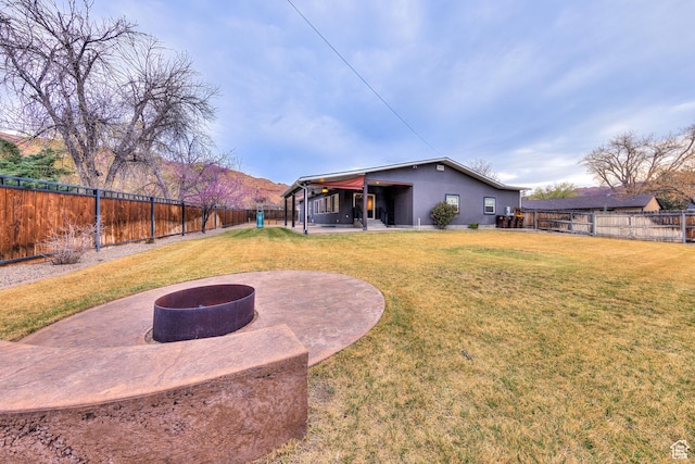 284 W Mcgill Blvd, Moab, UT 84532 - view of yard with a patio area, a fenced backyard, and a fire pit