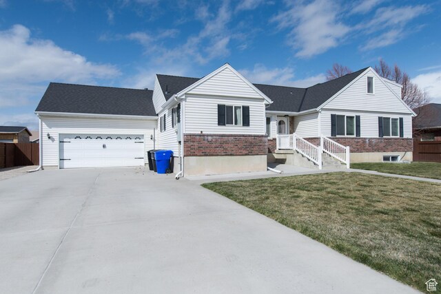 485 N 400 W, Tremonton, UT 84337 - ranch-style house with concrete driveway, a front yard, brick siding, a garage, and fence