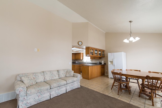 485 N 400 W, Tremonton, UT 84337 - living room with high vaulted ceiling, visible vents, a chandelier, light carpet, and light tile patterned flooring