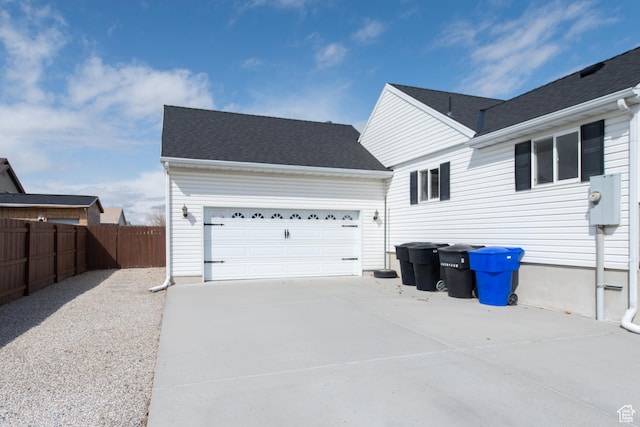 485 N 400 W, Tremonton, UT 84337 - view of side of home featuring concrete driveway, fence, and an attached garage