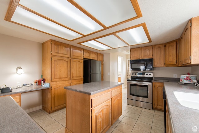 485 N 400 W, Tremonton, UT 84337 - kitchen featuring light tile patterned floors, a sink, black appliances, and a kitchen island