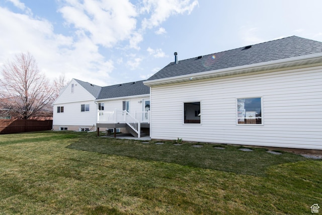 485 N 400 W, Tremonton, UT 84337 - back of house with a lawn, stairway, a wooden deck, fence, and a shingled roof