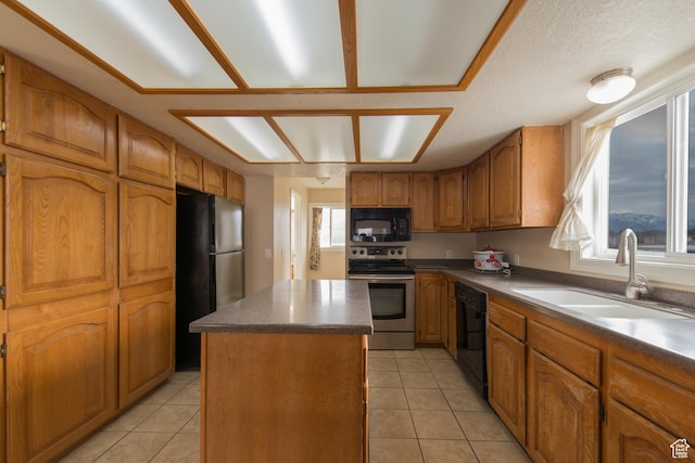 485 N 400 W, Tremonton, UT 84337 - kitchen with light tile patterned flooring, black appliances, a kitchen island, brown cabinetry, and a sink