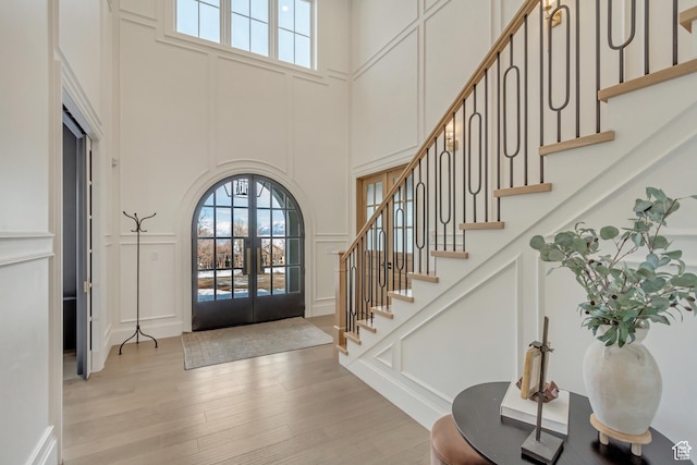 70 E Deer Meadow Ct, Woodland Hills, UT 84653 - entrance foyer with french doors, a towering ceiling, stairs, and a decorative wall