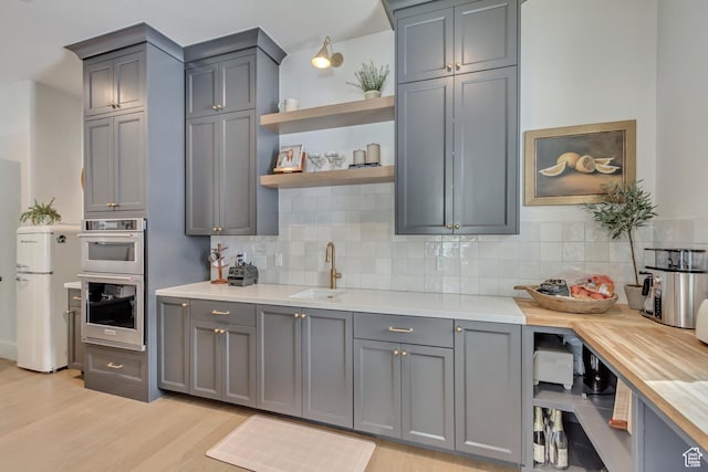 70 E Deer Meadow Ct, Woodland Hills, UT 84653 - kitchen featuring gray cabinets, a sink, light countertops, and freestanding refrigerator
