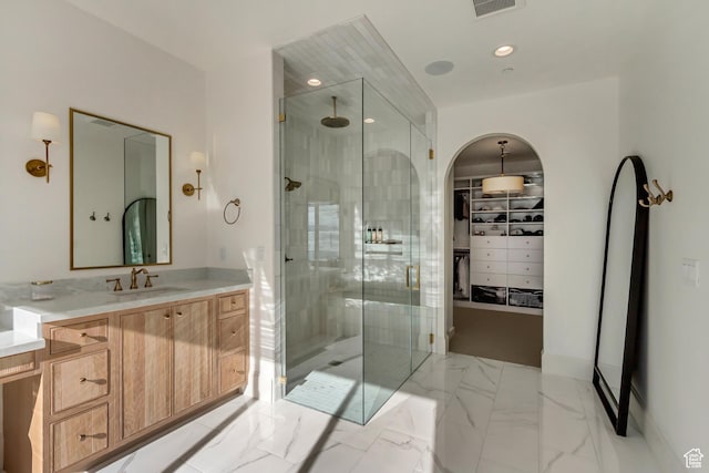 70 E Deer Meadow Ct, Woodland Hills, UT 84653 - full bath with marble finish floor, visible vents, vanity, a walk in closet, and a stall shower