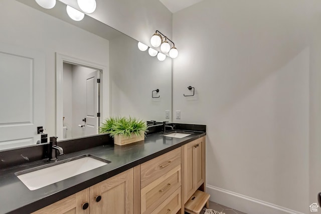 70 E Deer Meadow Ct, Woodland Hills, UT 84653 - bathroom with double vanity, toilet, baseboards, and a sink