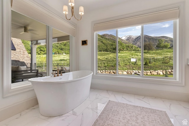 70 E Deer Meadow Ct, Woodland Hills, UT 84653 - full bathroom featuring marble look tile flooring, a mountain view, a freestanding tub, and baseboards