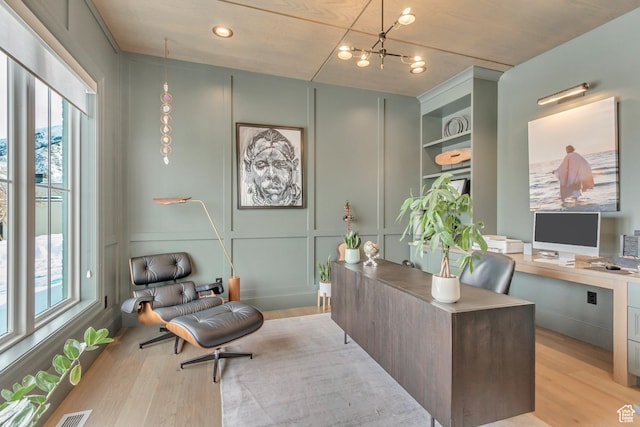70 E Deer Meadow Ct, Woodland Hills, UT 84653 - home office with light wood-type flooring, a chandelier, and a decorative wall