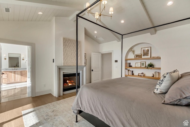 70 E Deer Meadow Ct, Woodland Hills, UT 84653 - bedroom with vaulted ceiling with beams, a glass covered fireplace, recessed lighting, an inviting chandelier, and wood finished floors