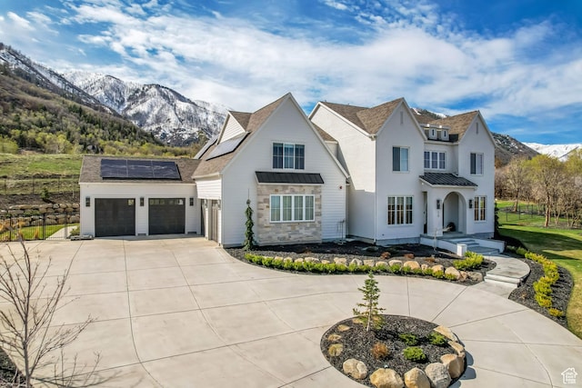 70 E Deer Meadow Ct, Woodland Hills, UT 84653 - modern farmhouse style home with a garage, roof mounted solar panels, concrete driveway, and a mountain view