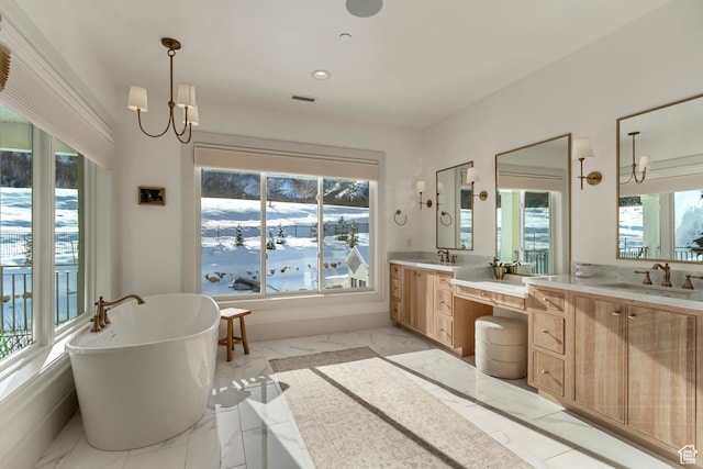 70 E Deer Meadow Ct, Woodland Hills, UT 84653 - bathroom with marble finish floor, two vanities, a soaking tub, and a sink