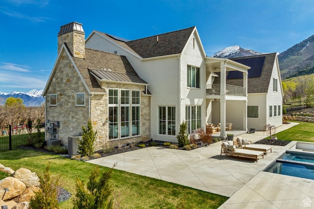 70 E Deer Meadow Ct, Woodland Hills, UT 84653 - back of house with a patio area, a balcony, stone siding, a mountain view, and fence