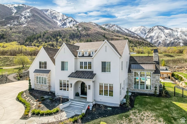 70 E Deer Meadow Ct, Woodland Hills, UT 84653 - view of front of property featuring a standing seam roof, a mountain view, stone siding, metal roof, and fence