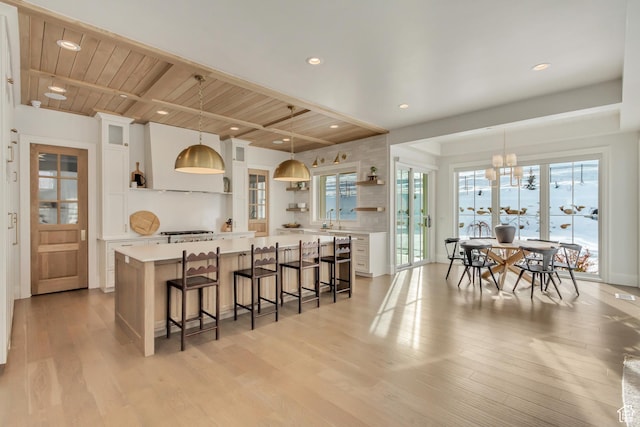 70 E Deer Meadow Ct, Woodland Hills, UT 84653 - kitchen featuring open shelves, light countertops, an inviting chandelier, light wood-style flooring, and white cabinets