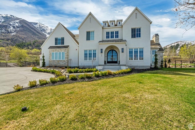 70 E Deer Meadow Ct, Woodland Hills, UT 84653 - view of front of house featuring a front lawn, fence, a mountain view, stucco siding, and a standing seam roof