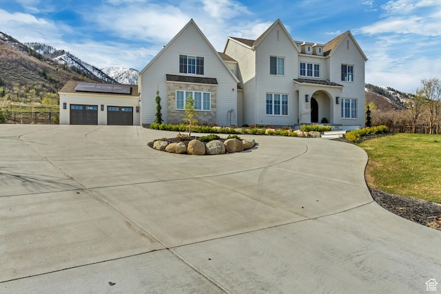 70 E Deer Meadow Ct, Woodland Hills, UT 84653 - modern farmhouse style home featuring concrete driveway, roof mounted solar panels, a mountain view, and stone siding