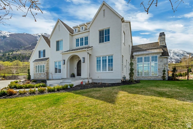 70 E Deer Meadow Ct, Woodland Hills, UT 84653 - view of front facade with a chimney, fence, a front yard, and a mountain view