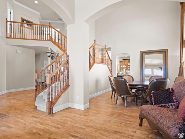 interior space featuring stairway, wood finished floors, and a towering ceiling