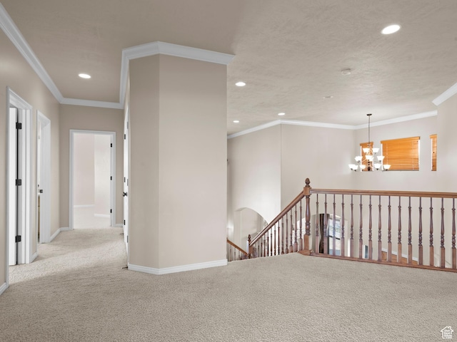 carpeted spare room with recessed lighting, baseboards, an inviting chandelier, and crown molding